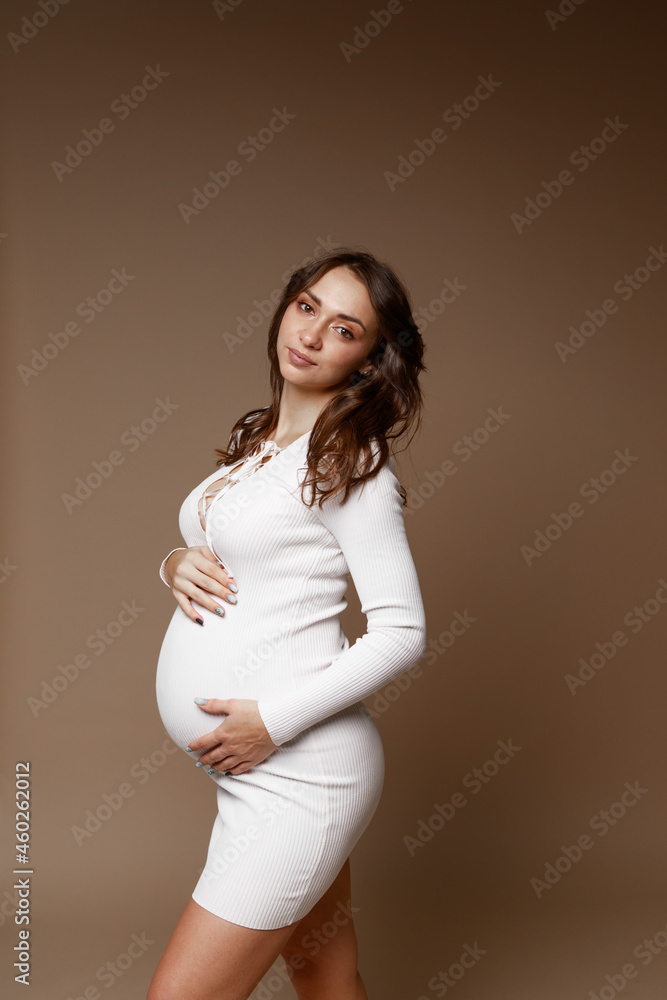 pregnant girl in studio on paper background pregnant girl in studio on paper background