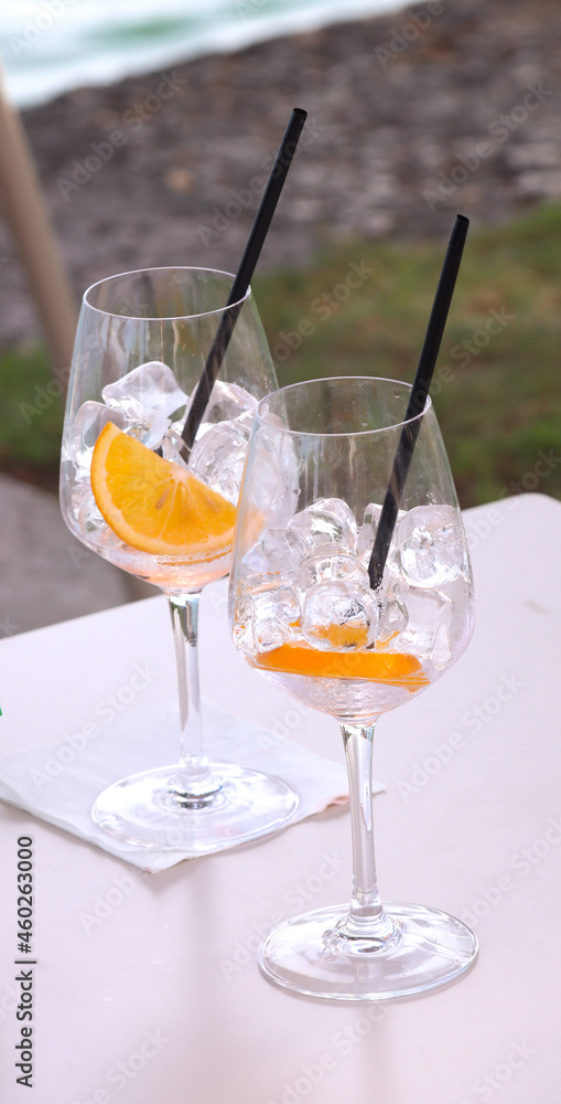 empty goblets with ice and orange slice on the table