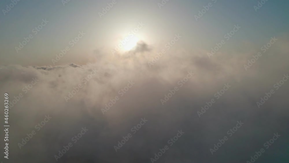 Fly through the clouds during sunrise. An epic shot of clouds in morning colors. Fly through the clouds during sunrise. An epic shot of clouds in morning colors.