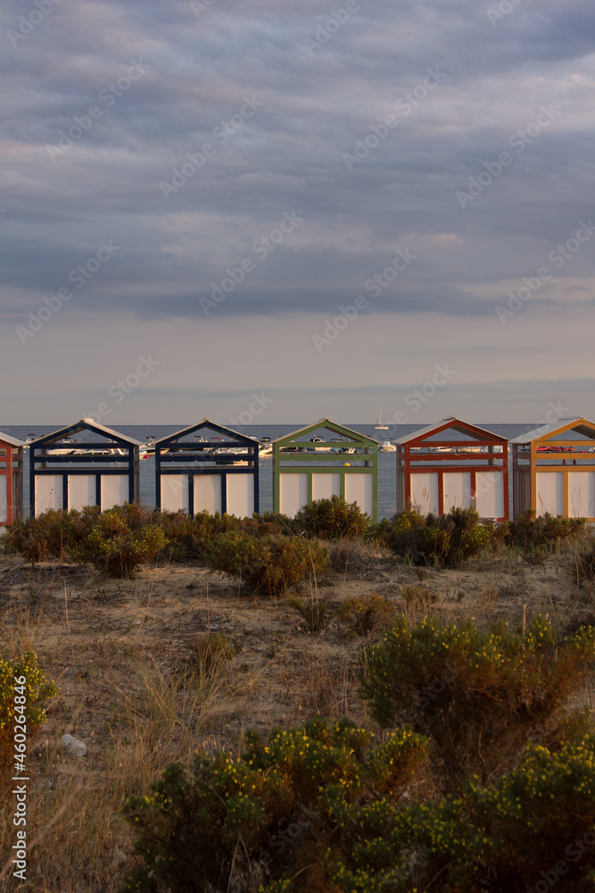 Multicolored bathing huts on the Costa Brava at the beach of Sant Pol, Sant Feliu de Guixols