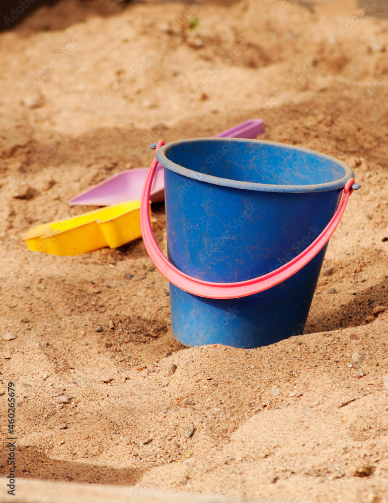plastic bucket and toys on a beach or sandbox plastic bucket and toys on a beach or sandbox