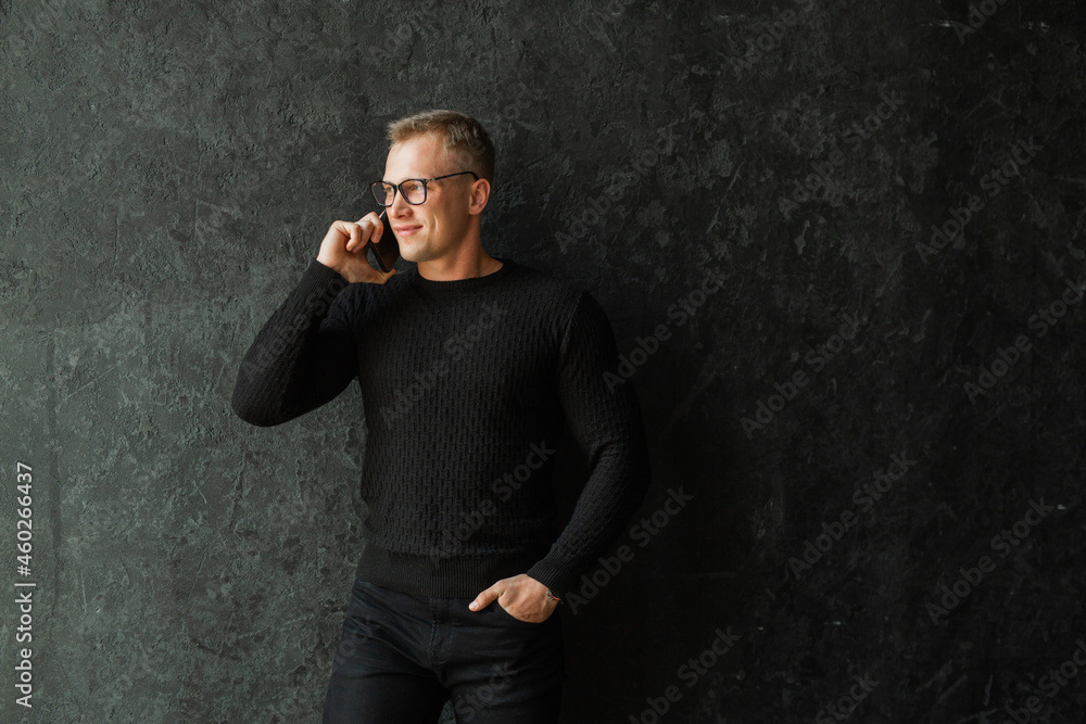 attractive caucasian male with glasses talking on a cell phone 