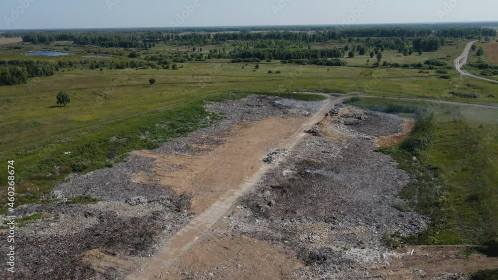 The city dump is on fire. Birds fly over food waste. Environmental pollution. Bird's-eye view, aerial photography. The city dump is on fire. Birds fly over food waste. Environmental pollution. Bird's-eye view, aerial photography.