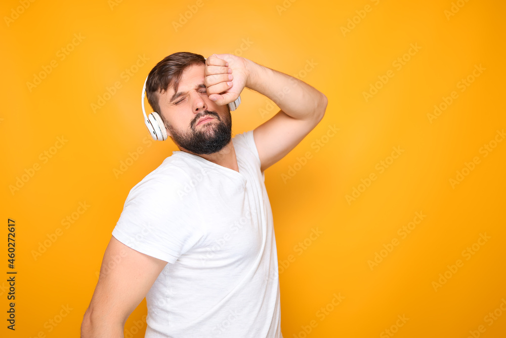 bearded man in headphones emotionally performs dance movements to music. bearded man in headphones emotionally performs dance movements to music.