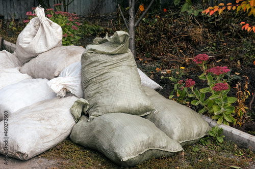 Big heap of full bags with garden garbage outdoors © rosinka79