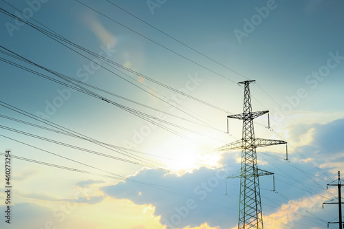 Telephone pole with cables under blue sky outdoors