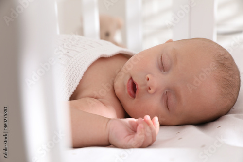 Cute little baby sleeping in crib, closeup