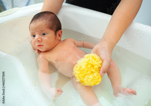 First bath of newborn baby boy.