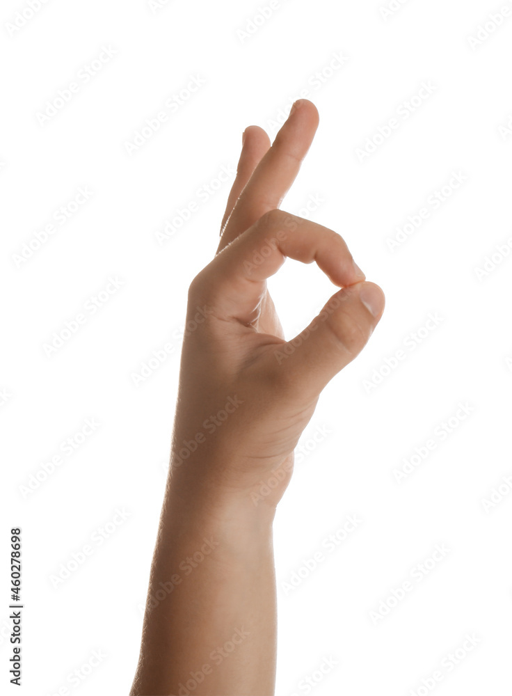 Naklejka premium Teenage boy showing ok gesture on white background, closeup
