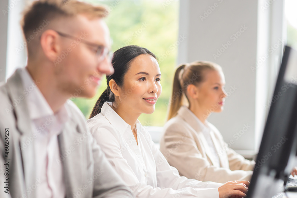 Diverse team of young professionals is working in the e-mail support center. Working day of sales managers in office. Business, consulting, and problem solving via email. Diverse team of young professionals is working in the e-mail support center. Working day of sales managers in office. Business, consulting, and problem solving via email.