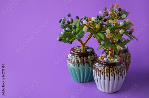 Fototapeta Naklejka Na Ścianę i Meble -  artificial jade tree For decorating your desk and giving as a gift on a purple background.