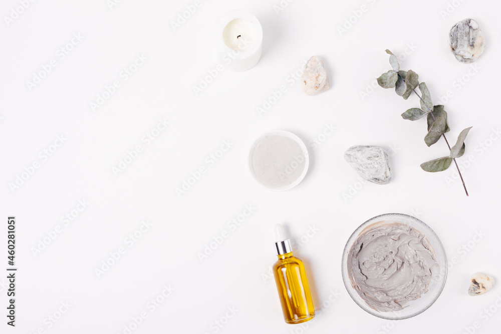 Cosmetic clay facial mask next to organic oil Cosmetic clay facial mask next to organic oil