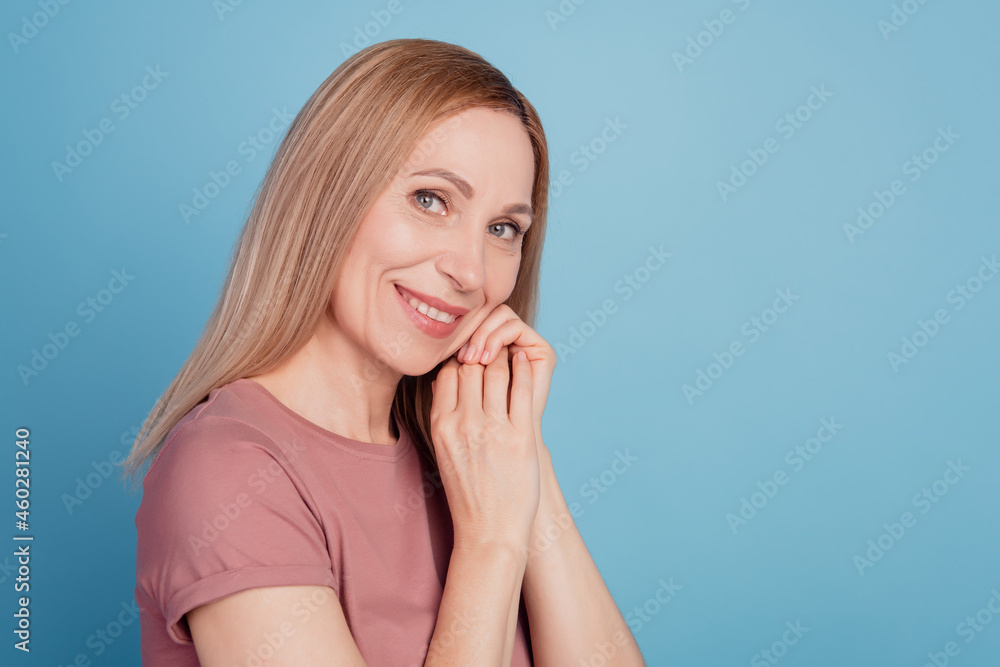 Profile side photo of attractive woman happy positive smile hands touch chin isolated blue color background Profile side photo of attractive woman happy positive smile hands touch chin isolated blue color background