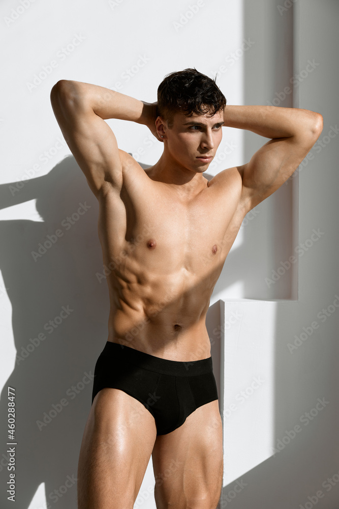 sexy man with muscular body black panties posing studio