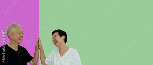 Asian senior couple high five gesture on isolated background support each other partner in life positive energy