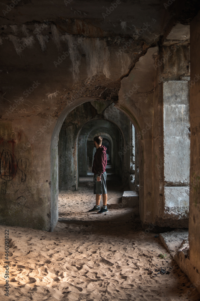 Person in an Polish abandoned fort, under the arch.