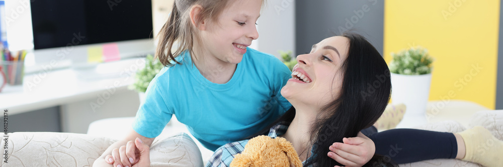 Young mother hugs her daughter after quarrel Young mother hugs her daughter after quarrel