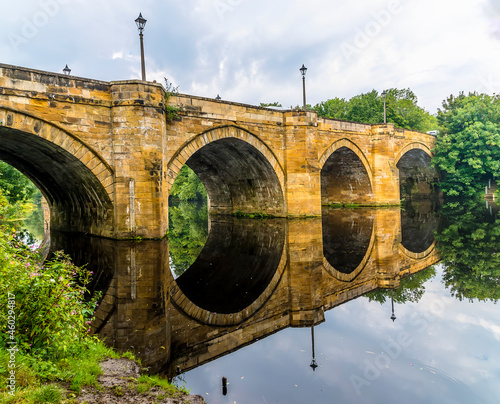 Reflections of the Yarm Road Bridge over the River Tees at Yarm, Yorkshire, UK in summertime photo