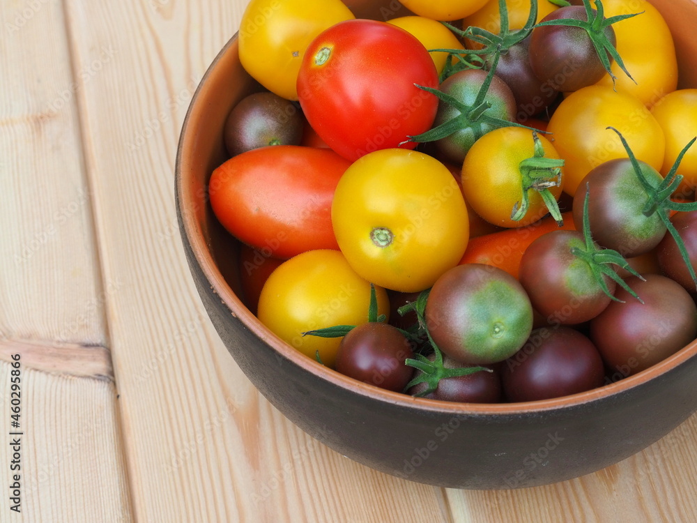 Tomatoes of different colors on the table. Greenhouse yield. Market prices. Fresh tomatoes Tomatoes of different colors on the table. Greenhouse yield. Market prices. Fresh tomatoes