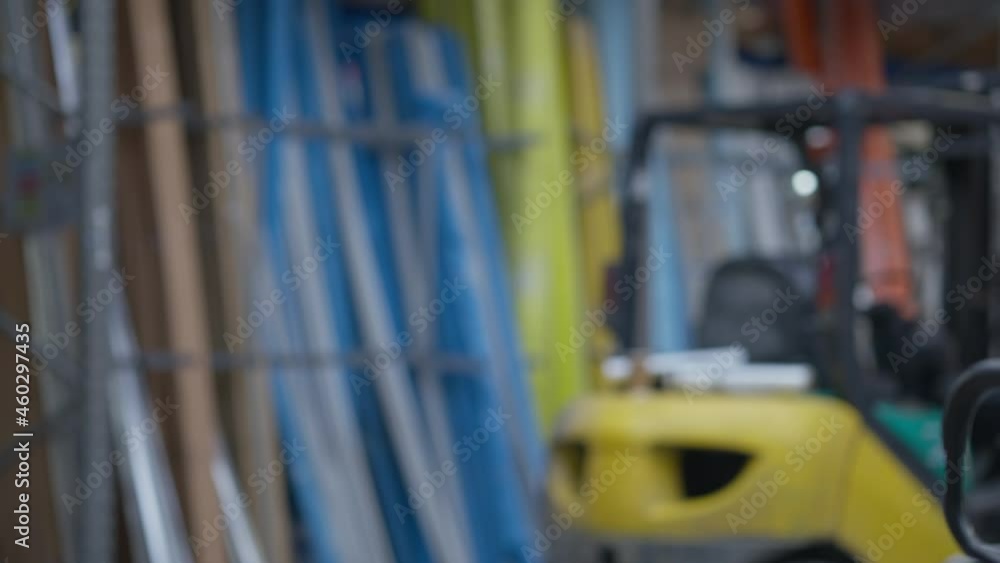 Cheerful woman making victory gesture looking at camera smiling and walking away in industrial warehouse. Portrait of satisfied Caucasian joyful female employee rejoicing deadlines fulfillment Cheerful woman making victory gesture looking at camera smiling and walking away in industrial warehouse. Portrait of satisfied Caucasian joyful female employee rejoicing deadlines fulfillment