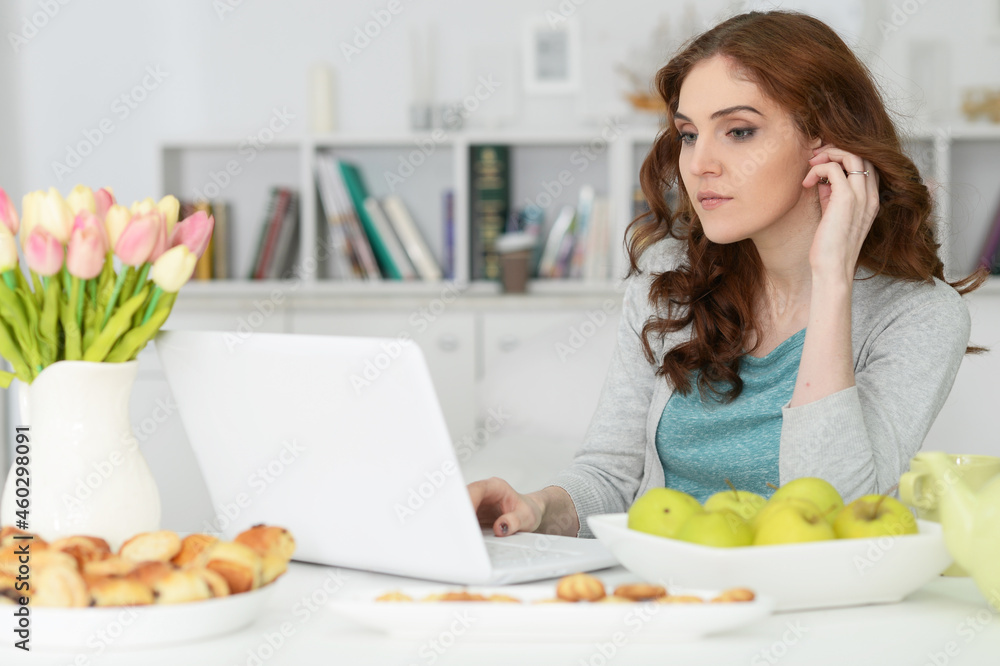 Beautiful young woman using laptop at table Beautiful young woman using laptop at table