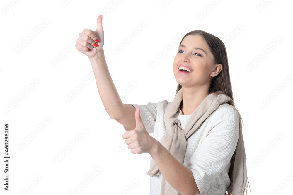 Portrait of beautiful young woman with long hair showing thumbs up Portrait of beautiful young woman with long hair showing thumbs up