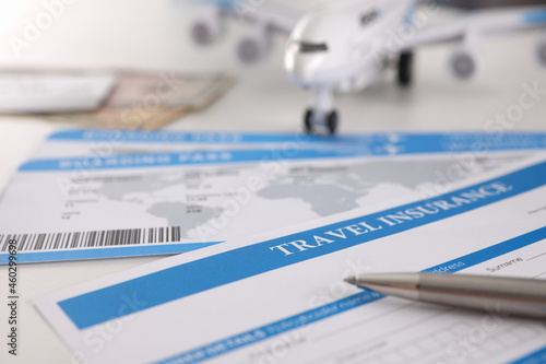 Medical insurance contract for tourists pen and plane on table