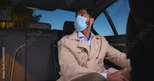 Wallpaper Mural Middle-eastern man in protective face mask sitting on backseat in taxi Torontodigital.ca