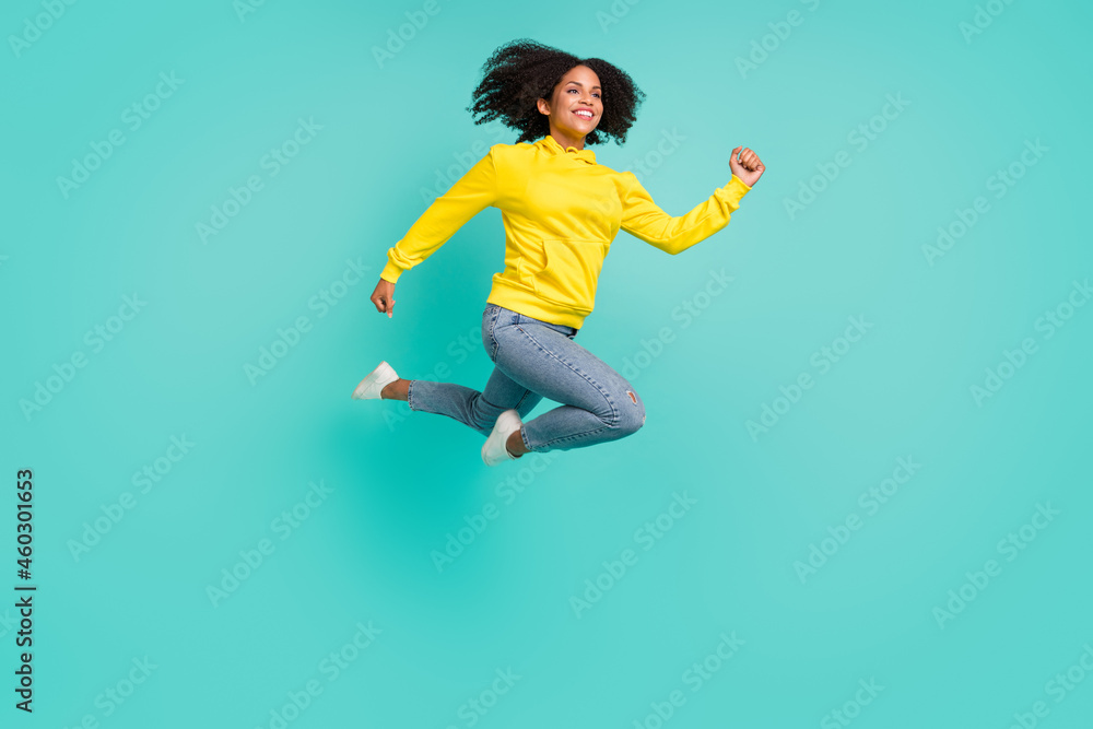 Full length body size view of pretty active cheerful girl jumping running isolated over bright teal turquoise color background
