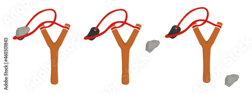 Wooden slingshot with flying stone photo