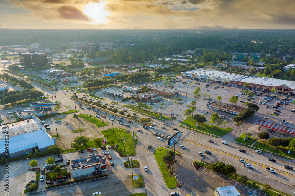Aerial view shopping district parking lot near major road 45 interchanges view overlooking in Houston city Texas USA