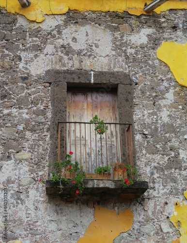 old window with flowers in San Miguel de Allende, Mexico