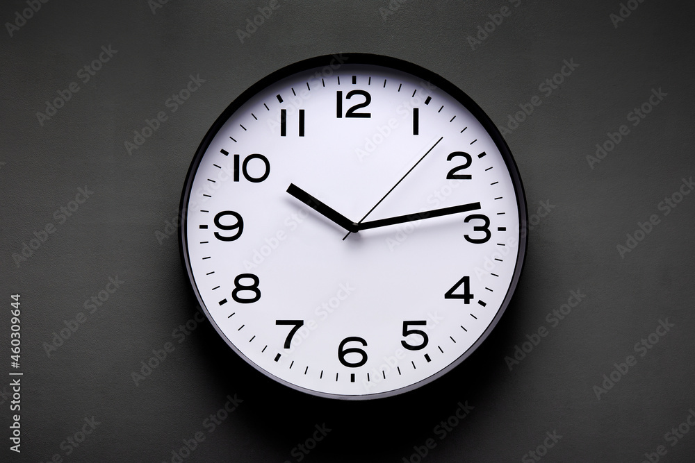 Clock with numbers and arrows hanging on wall Clock with numbers and arrows hanging on wall
