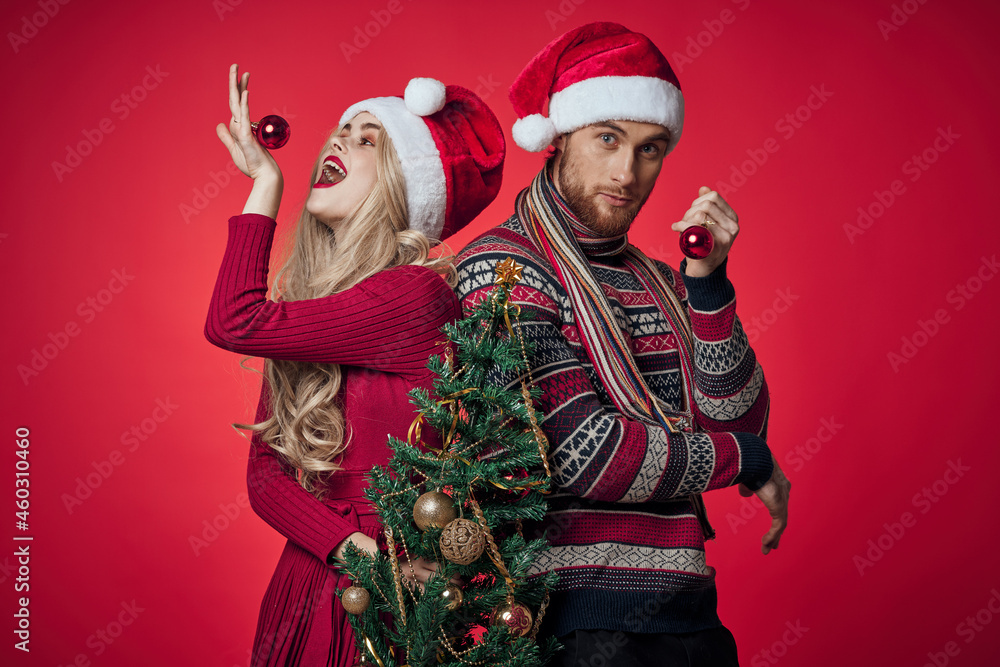 cheerful young couple Christmas tree toys holiday red background cheerful young couple Christmas tree toys holiday red background