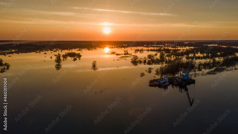 Aerial atmospheric view on big river. Aerial drone view of river landscape in sunny sunset. Nature concept.
