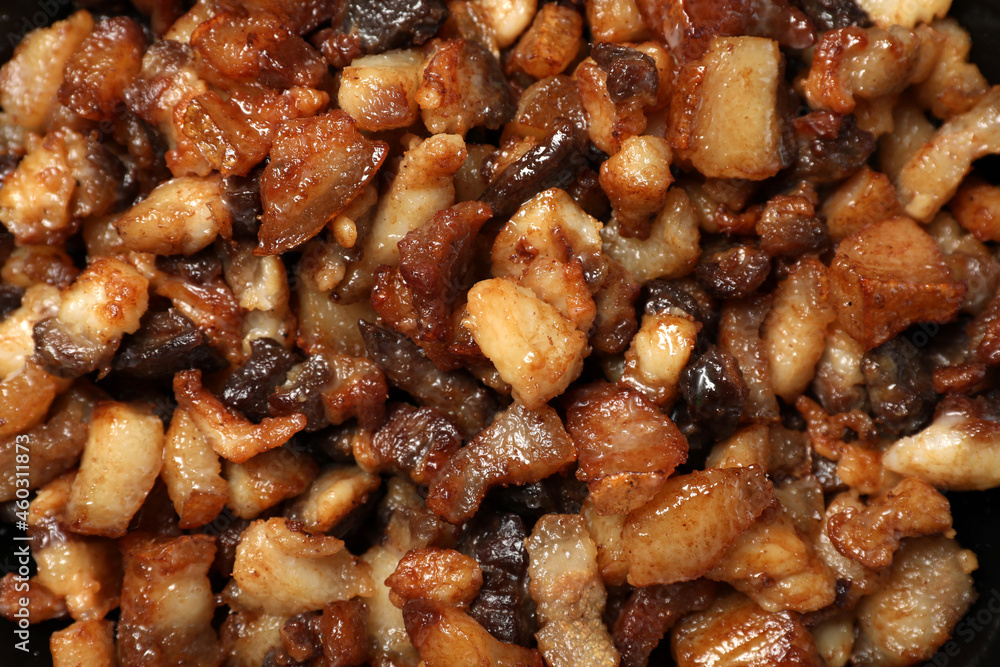 Tasty fried cracklings as background, top view. Cooked pork lard