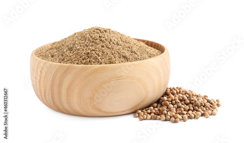 Wooden bowl with powdered coriander and corns on white background photo