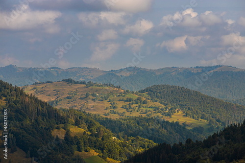 mountain slopes in the Ukrainian Carpathians. mountain tops and forests on a background of blue sky © Oleh Marchak
