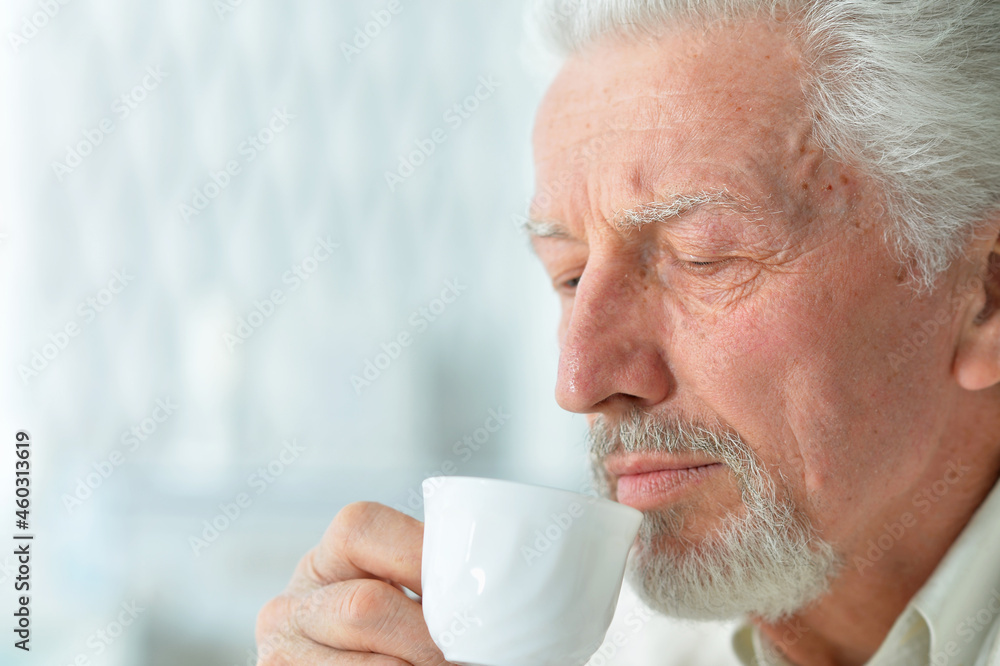 Portrait of smiling senior man drinking coffee Portrait of smiling senior man drinking coffee
