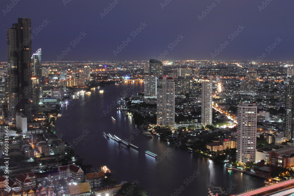 The Cityscape, the Skyscraper and the Chao Phraya River of Bangkok Thailand in the Night