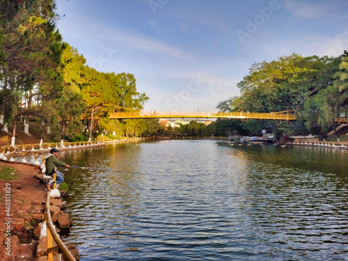 View of the Cầu Treo KDL Hồ Diên Hồng Bridge over the Hồ Đức An pond at Dien Hong Lake Resort in Pleiku. Gia Lai Province. Vietnam. South-East Asia