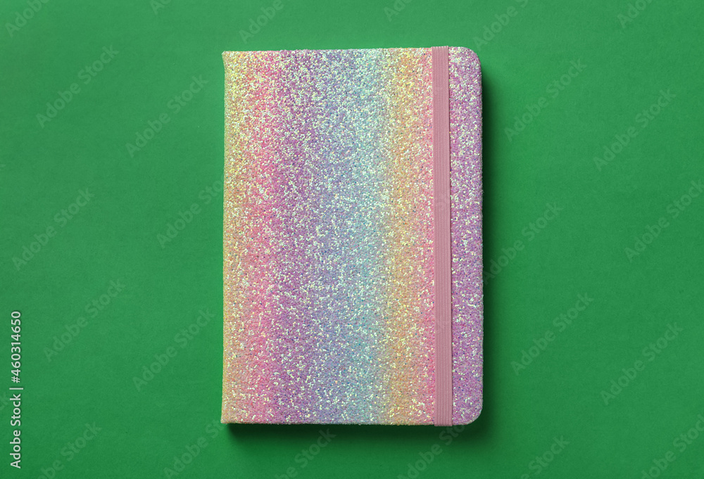 Fototapeta premium New stylish planner with hard cover on green background, top view