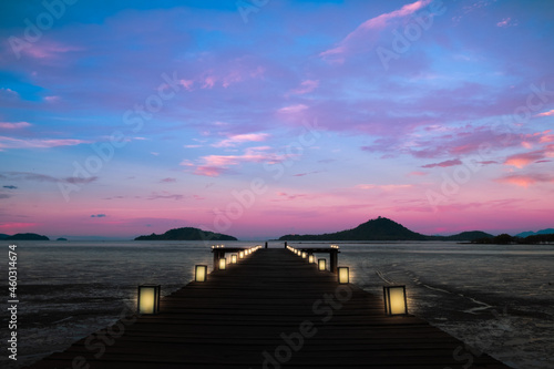 twilight background beautiful pier decorated with lanterns in silent sea at the sunrise or sunset