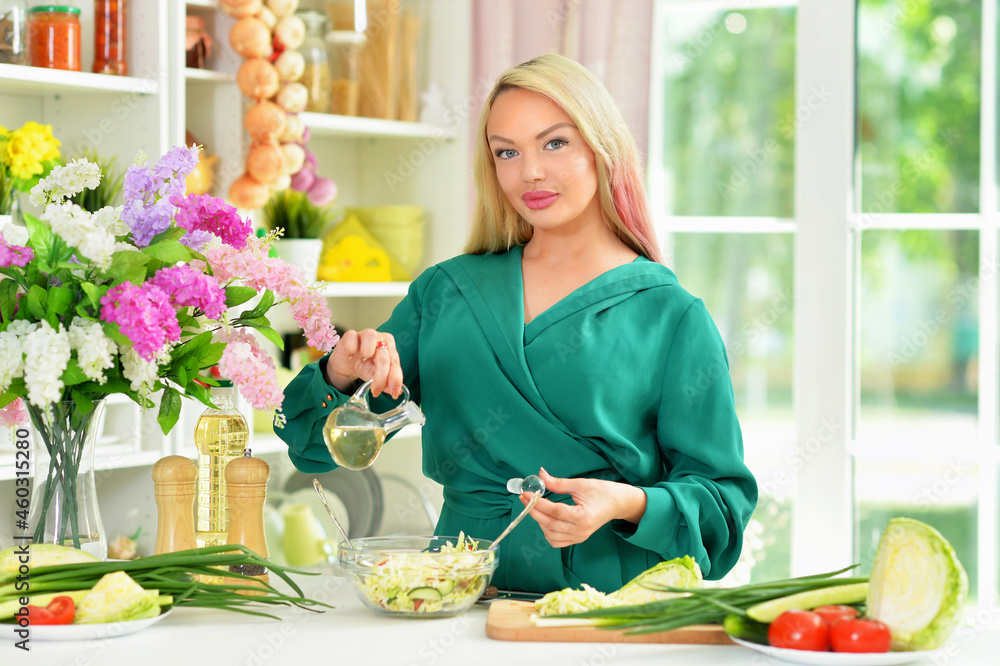 Portrait of beautiful young woman cooking in kitchen Portrait of beautiful young woman cooking in kitchen