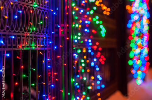 Fototapeta Naklejka Na Ścianę i Meble -  Christmas garlands glow at night with a beautiful bokeh for design