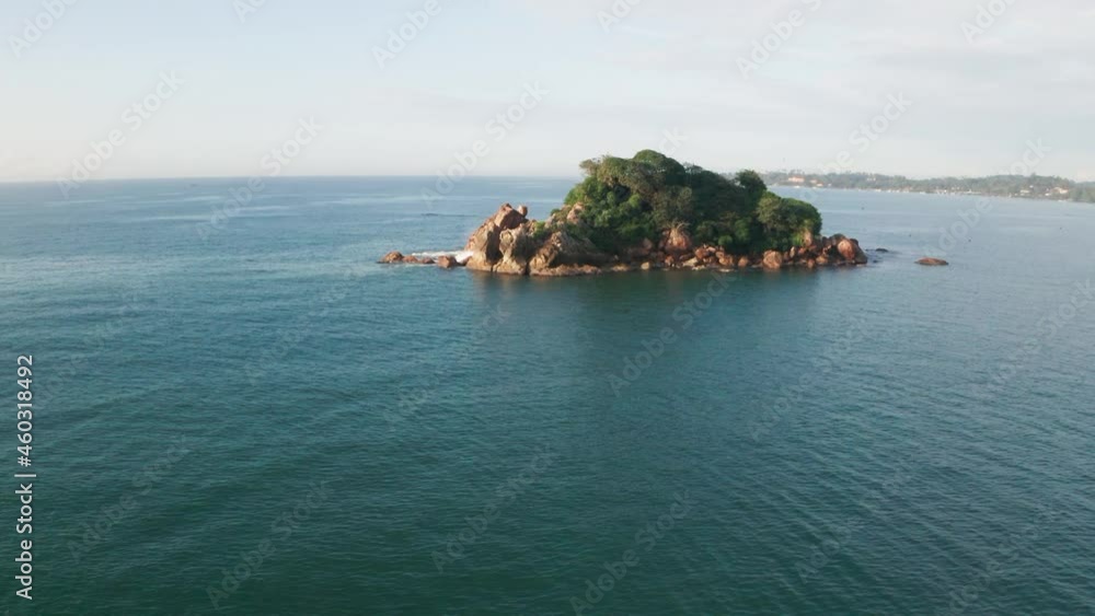 Aerial view of Taprobane Island in Weligama Bay during a hot sunny day in Sri Lanka. An island near the coastline, turquoise water, Indian Ocean, SouthEast Asia. Summer and travel vacation concept Aerial view of Taprobane Island in Weligama Bay during a hot sunny day in Sri Lanka. An island near the coastline, turquoise water, Indian Ocean, SouthEast Asia. Summer and travel vacation concept