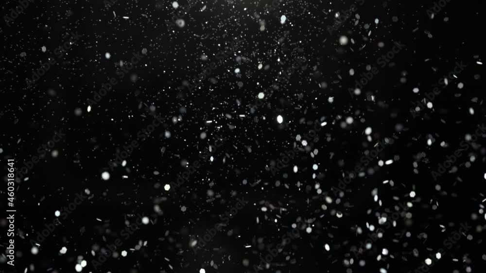 Super slow motion of glittering golden particles on black background. Shallow depth of focus. Filmed on high speed cinema camera, 1000 fps. Super slow motion of glittering golden particles on black background. Shallow depth of focus. Filmed on high speed cinema camera, 1000 fps.
