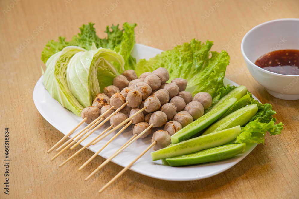 Pork meatballs with spicy sauce on wood table Pork meatballs with spicy sauce on wood table