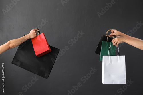 Photographie Crop of hand holding shopping bag or goodie bag for shopaholic or online shoppin