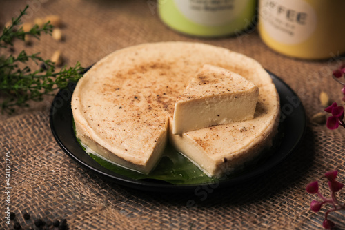 Junnu Kharvas milk pudding or cake known as ginnu in kannada and kharvas in Marathi served in a plate closeup with selective focus and blur photo